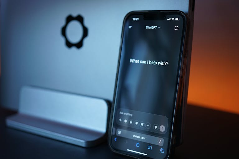 Close-up of a smartphone with AI chat interface, showcasing advanced technology in a sleek design.